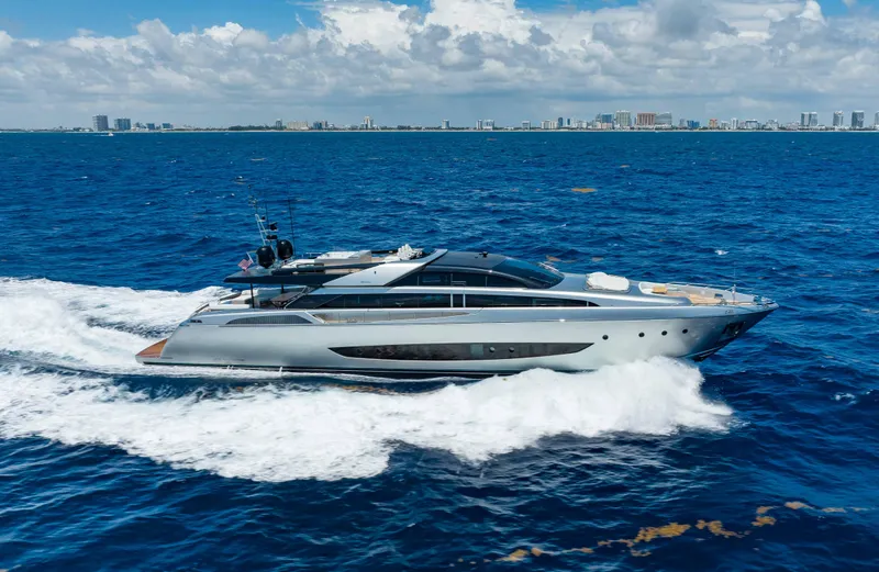 Slide: The Image of 2014 Riva Mythos Motoryacht cruising on open sea with city skyline in background. - 7