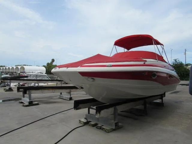 The Image of 2016 Crownline 255 SS boat with red cover on a dock. - 1