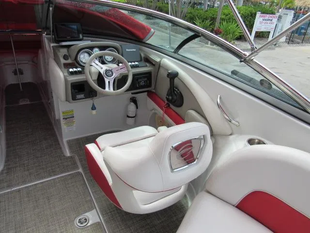 Slide: The Image of 2016 Crownline 255 SS boat interior with steering wheel and seating. - 11