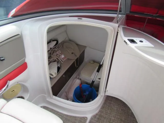 Slide: The Image of 2016 Crownline 255 SS boat storage compartment with various items. - 15