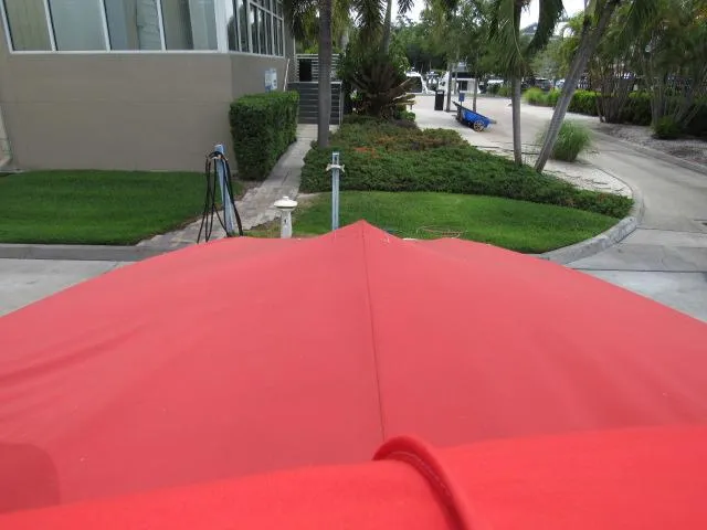 Slide: The Image of 2016 Crownline 255 SS boat with red cover in a marina. - 17