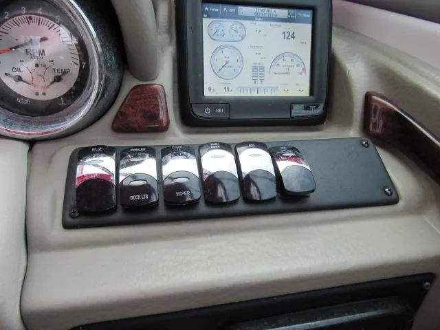 Slide: The Image of Control panel of a 2016 Crownline 255 SS boat with gauges and switches. - 28