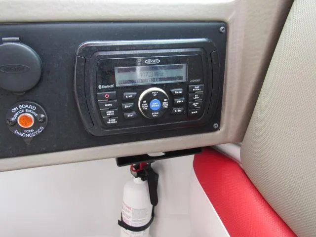Slide: The Image of Dashboard of a 2016 Crownline 255 SS boat with a marine radio and fire extinguisher. - 29