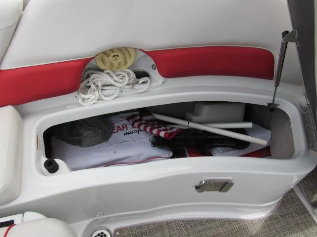 Slide: The Image of 2016 Crownline 255 SS boat storage compartment with ropes and accessories. - 32