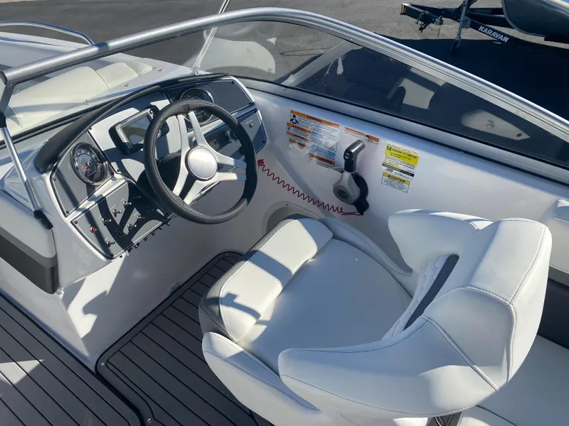 Slide: The Image of 2022 Hurricane SD217OB boat cockpit with steering wheel and captain's chair. - 7