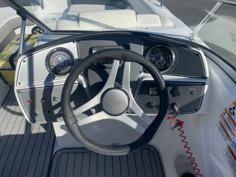 Slide: The Image of 2022 Hurricane SD217OB boat dashboard with steering wheel and instrument panel. - 8
