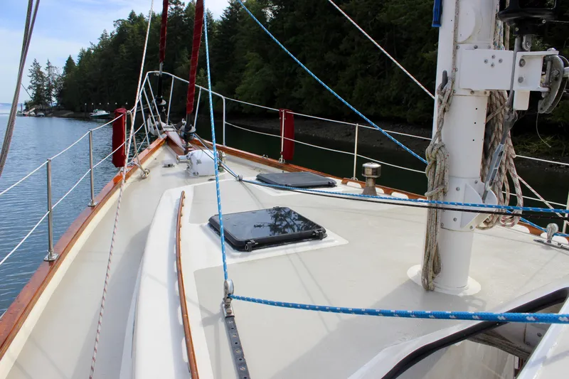 Slide: The Image of Sailboat deck view, Skookum 53, 1981 model, moored near forested shoreline. - 14