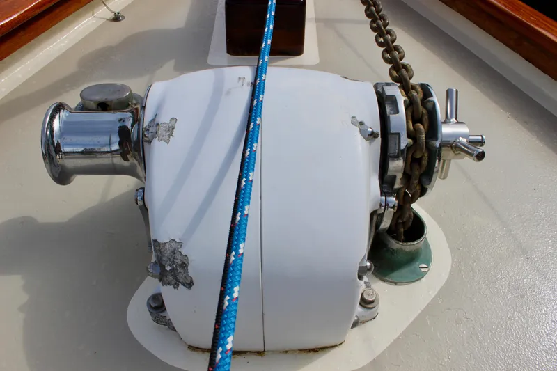 Slide: The Image of Anchor windlass on 1981 Skookum 53 sailboat deck with chain and rope. - 16