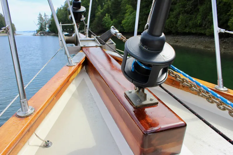 Slide: The Image of Sailboat deck view, Skookum 53, 1981 model, with lush forested shoreline in the background. - 17