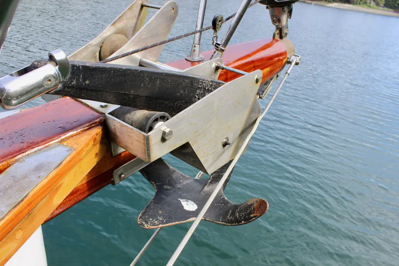 Slide: The Image of Anchor mechanism on 1981 Skookum 53 boat, positioned over calm water. - 19