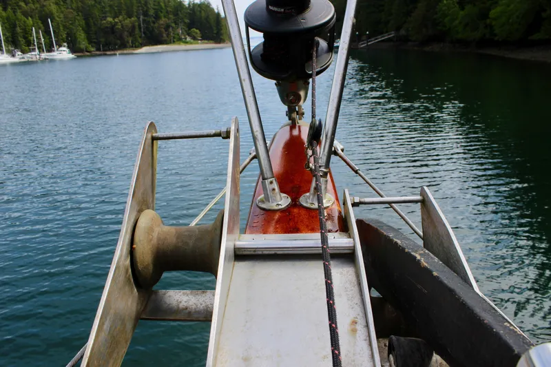 Slide: The Image of Bow of 1981 Skookum 53 boat with anchor equipment, docked in a serene harbor. - 20