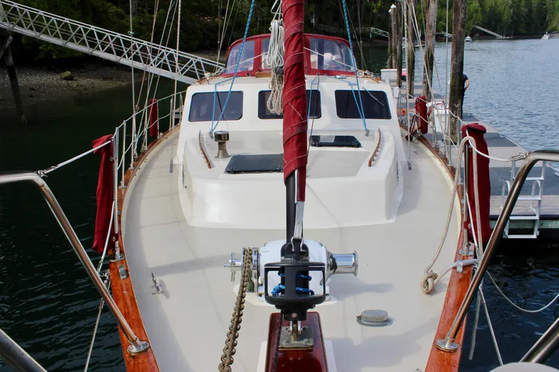 Slide: The Image of 1981 Skookum 53 sailboat docked, featuring a spacious deck and classic design. - 21