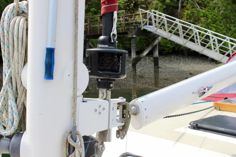 Slide: The Image of Sailboat rigging on a 1981 Skookum 53, dockside with forested background. - 24