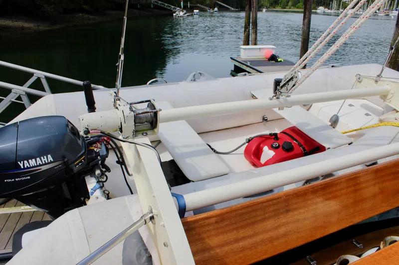 Slide: The Image of 1981 Skookum 53 sailboat with Yamaha outboard motor docked by the water. - 28
