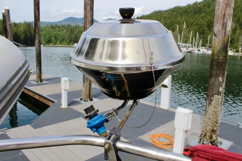 Slide: The Image of Stainless steel grill on a boat dock, surrounded by scenic lake and forest views. - 29