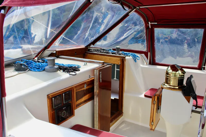 Slide: The Image of Interior of a 1981 Skookum 53 boat with red canopy and nautical equipment. - 34