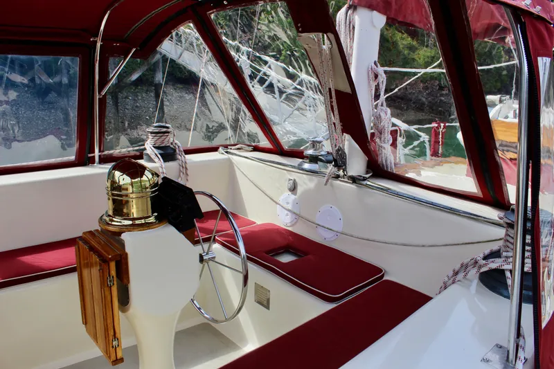 Slide: The Image of Interior of 1981 Skookum 53 sailboat with red upholstery and steering wheel. - 35