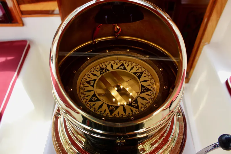 Slide: The Image of Brass compass on 1981 Skookum 53 yacht, displaying cardinal directions. - 40