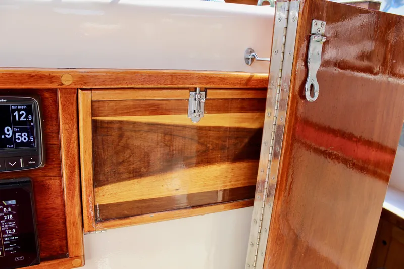 Slide: The Image of Wooden interior of 1981 Skookum 53 boat with navigation instruments and storage compartment. - 44