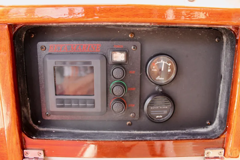 Slide: The Image of Control panel of a 1981 Skookum 53 boat with gauges and switches. - 45