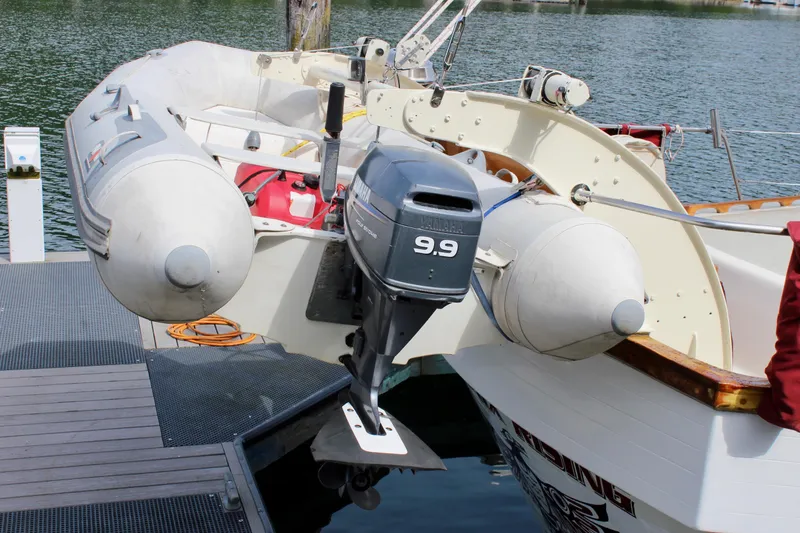 Slide: The Image of Inflatable boat with 9.9 horsepower motor docked beside Skookum 53, 1981 model. - 5