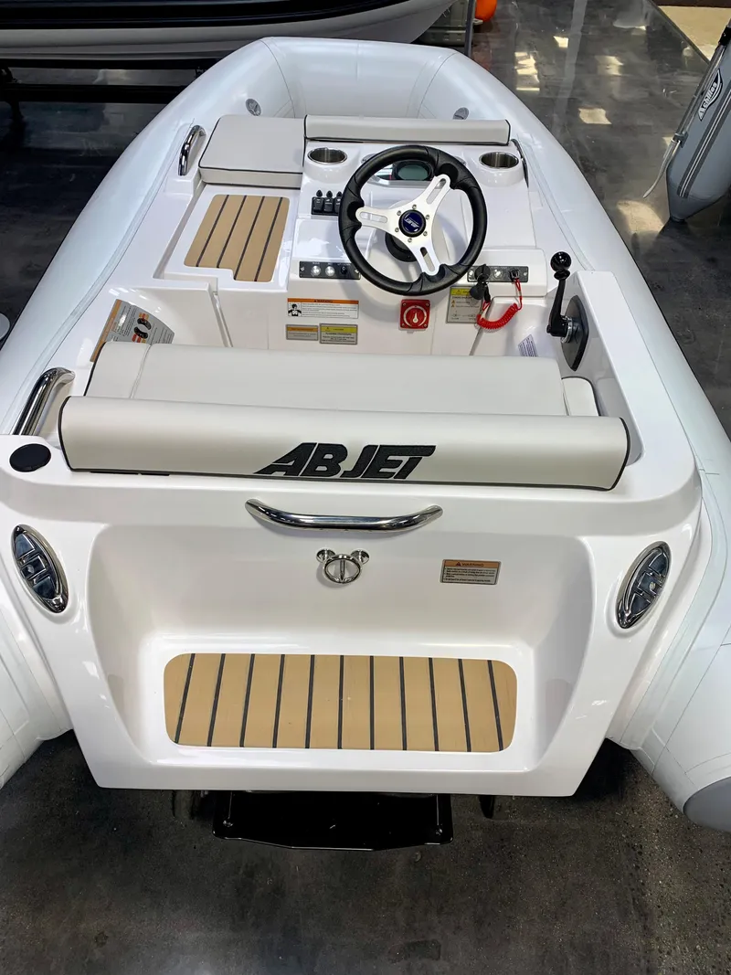 Slide: The Image of 2022 AB Inflatables Jet 290 boat with steering console and seating. - 2