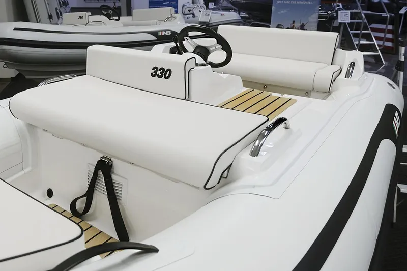 Slide: The Image of 2023 AB Inflatables JET 330 boat interior with white seating and steering console. - 5