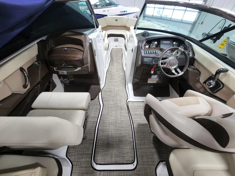 Slide: The Image of 2015 Monterey 268 Super Sport BR boat interior with beige seating and modern dashboard. - 4