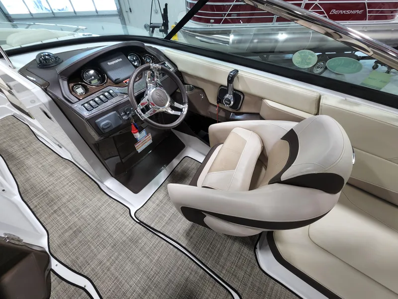 Slide: The Image of 2015 Monterey 268 Super Sport BR boat interior with captain's chair and control panel. - 5