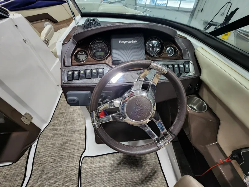 Slide: The Image of 2015 Monterey 268 Super Sport BR boat dashboard with Raymarine display and steering wheel. - 6