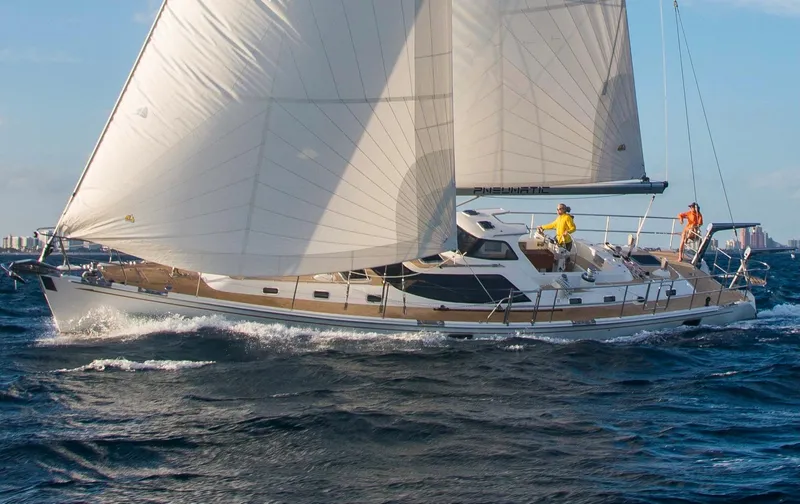 Slide: The Image of 2020 Bluewater 56 yacht sailing on open sea with crew on deck. - 2