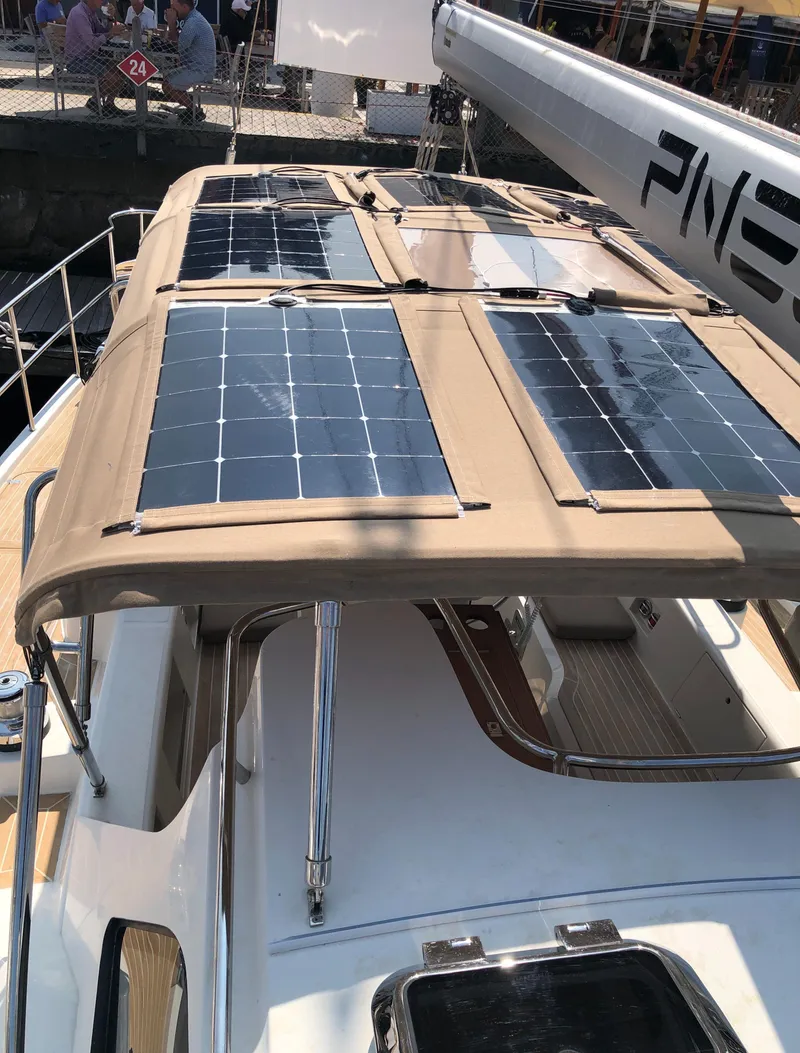 Slide: The Image of 2020 Bluewater 56 yacht with solar panels on deck, docked at marina. - 20