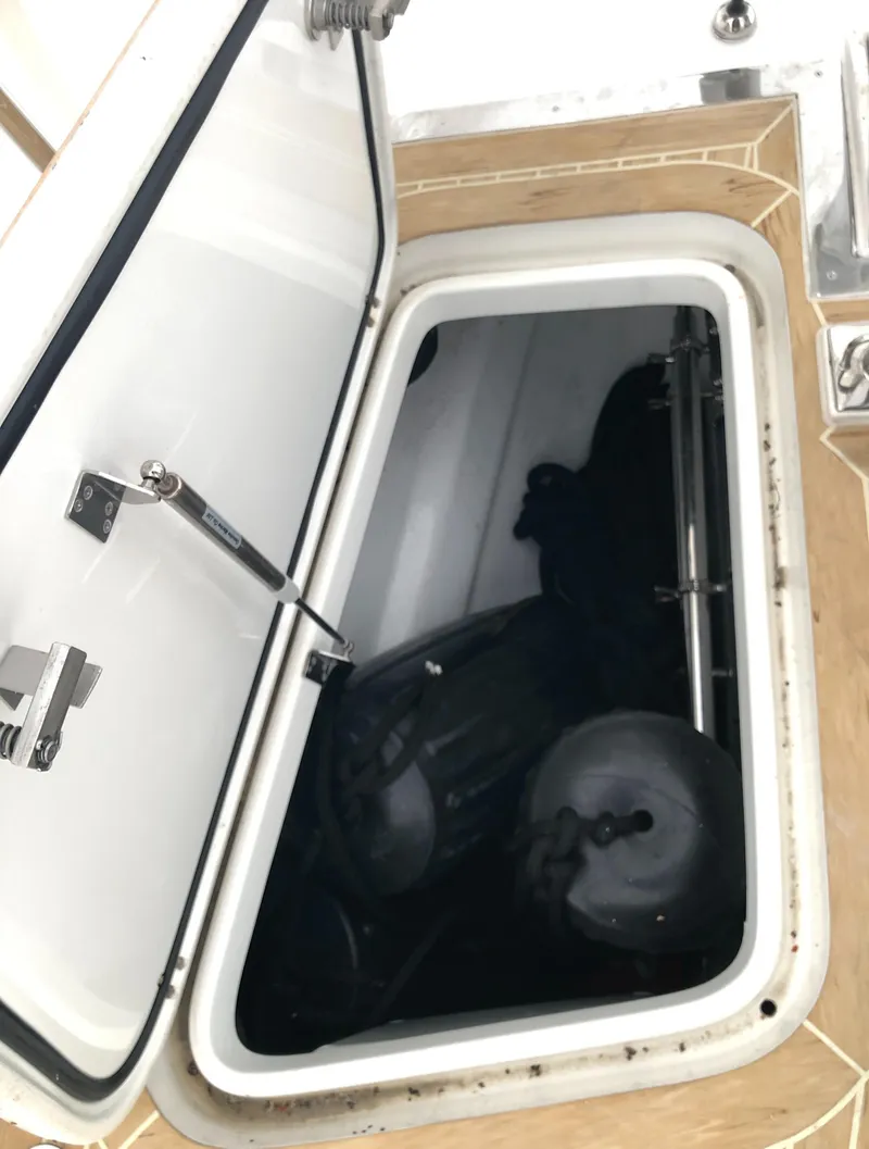 Slide: The Image of Open hatch on 2020 Bluewater 56 yacht, revealing interior storage compartment. - 25