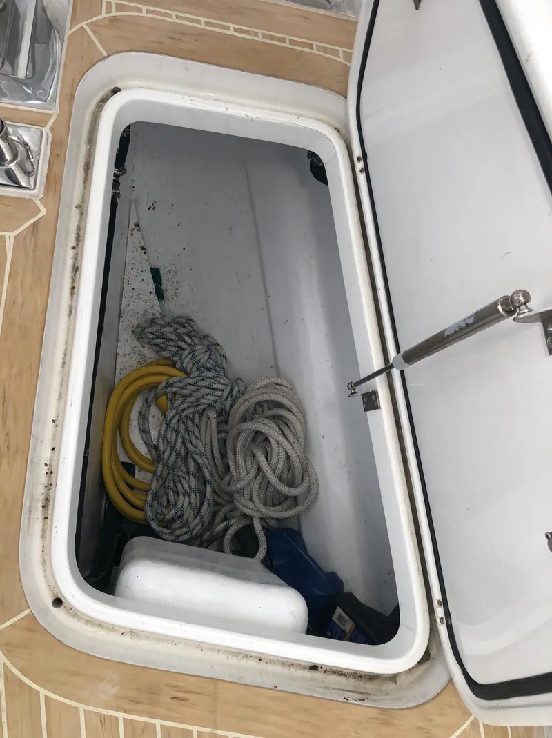 Slide: The Image of Open storage compartment on 2020 Bluewater 56 boat with ropes and equipment. - 26