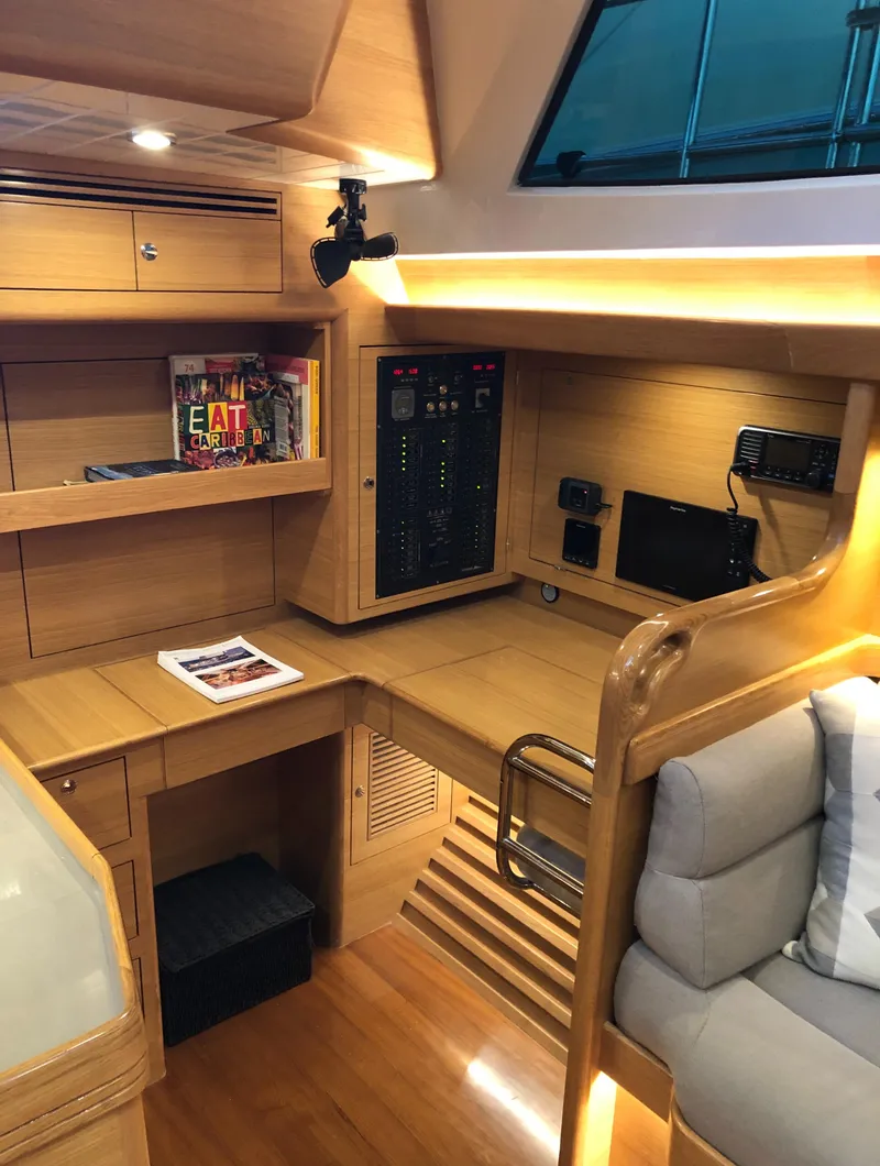 Slide: The Image of 2020 Bluewater 56 yacht interior with modern wood finish and navigation equipment. - 34