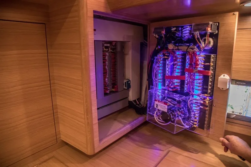 Slide: The Image of Electrical panel inside a 2020 Bluewater 56 yacht, featuring illuminated wiring and components. - 35