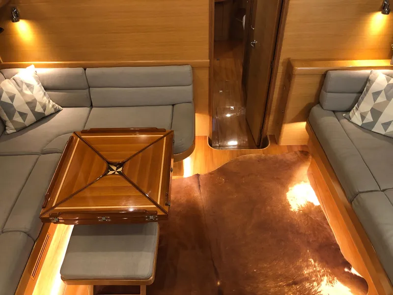 Slide: The Image of Luxurious interior of 2020 Bluewater 56 yacht with elegant seating and wooden table. - 39