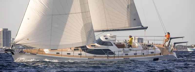 Slide: The Image of 2020 Bluewater 56 yacht sailing on open water with crew onboard. - 4