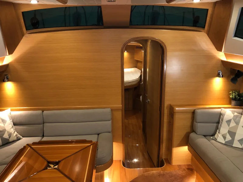 Slide: The Image of Luxurious interior of 2020 Bluewater 56 yacht with elegant wood finish and cozy seating. - 40