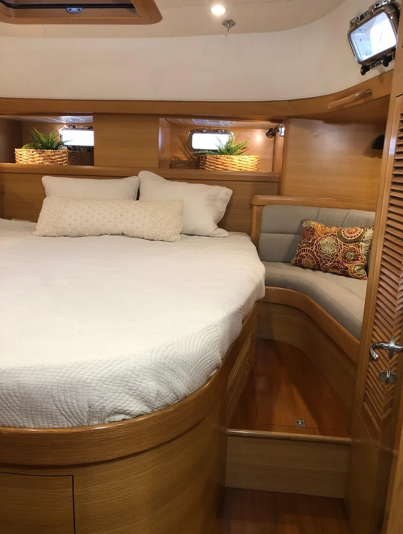 Slide: The Image of Luxurious Bluewater 56 yacht bedroom interior with cozy bedding and elegant wood finish, 2020 model. - 47