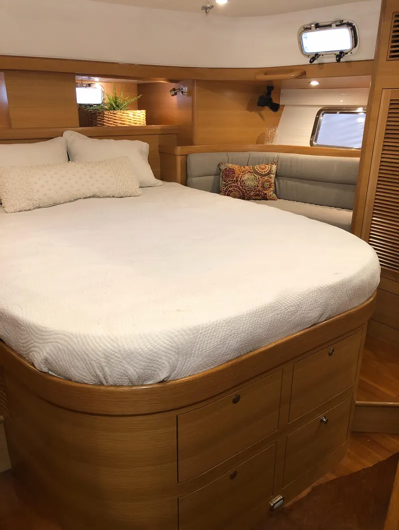 Slide: The Image of Luxurious cabin interior of 2020 Bluewater 56 yacht with cozy bed and seating area. - 48