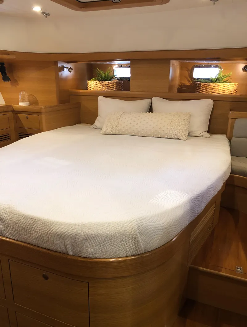 Slide: The Image of Luxurious cabin interior of 2020 Bluewater 56 yacht with cozy bed and wooden finish. - 49
