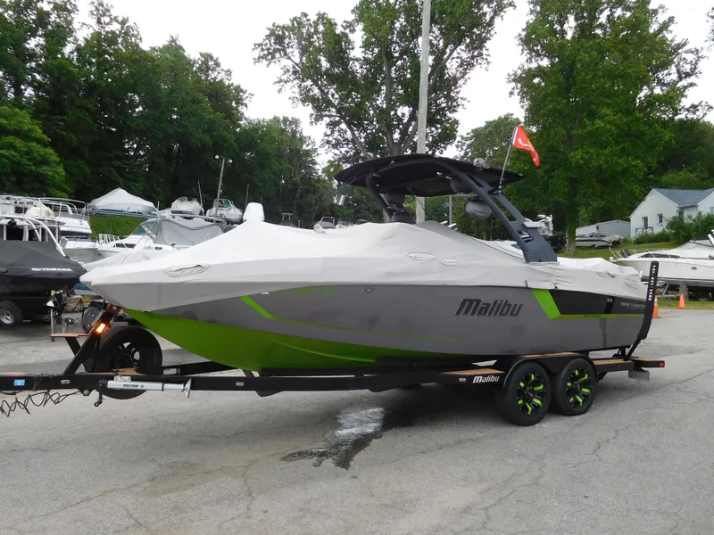 Slide: The Image of 2017 Malibu Wakesetter 24 MXZ boat on a trailer, covered and parked. - 10