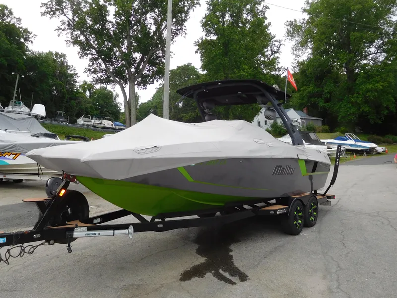 Slide: The Image of 2017 Malibu Wakesetter 24 MXZ boat on a trailer, covered and parked outdoors. - 11