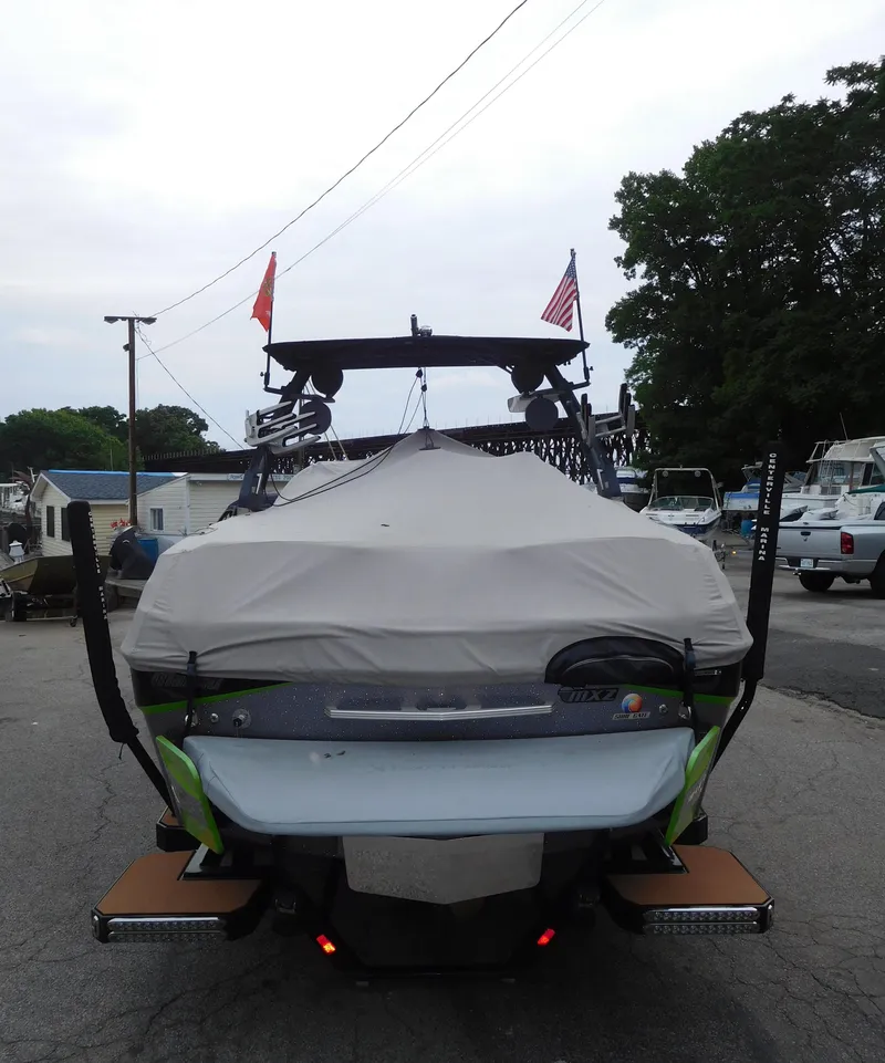 Slide: The Image of 2017 Malibu Wakesetter 24 MXZ boat, rear view with cover, parked outdoors. - 15