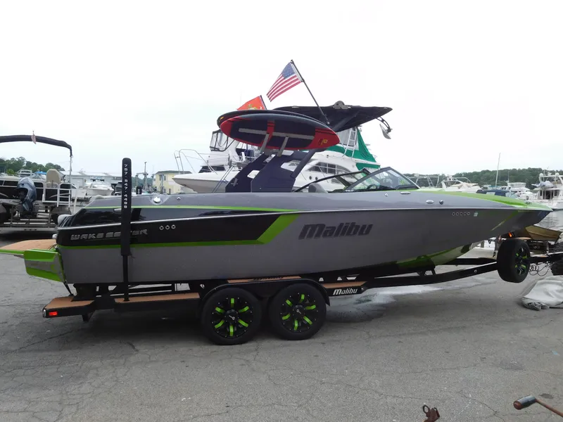 Slide: The Image of 2017 Malibu Wakesetter 24 MXZ boat on trailer at marina. - 2