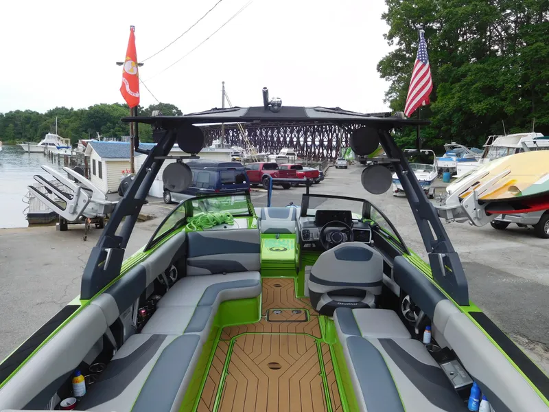 Slide: The Image of 2017 Malibu Wakesetter 24 MXZ boat at marina, interior view with seating and dashboard. - 20