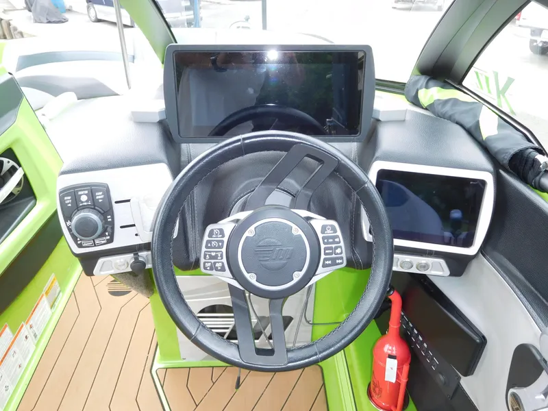 Slide: The Image of 2017 Malibu Wakesetter 24 MXZ dashboard with steering wheel and digital displays. - 33