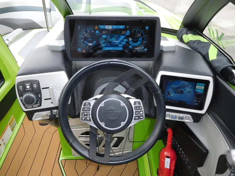 Slide: The Image of 2017 Malibu Wakesetter 24 MXZ boat dashboard with steering wheel and digital displays. - 36