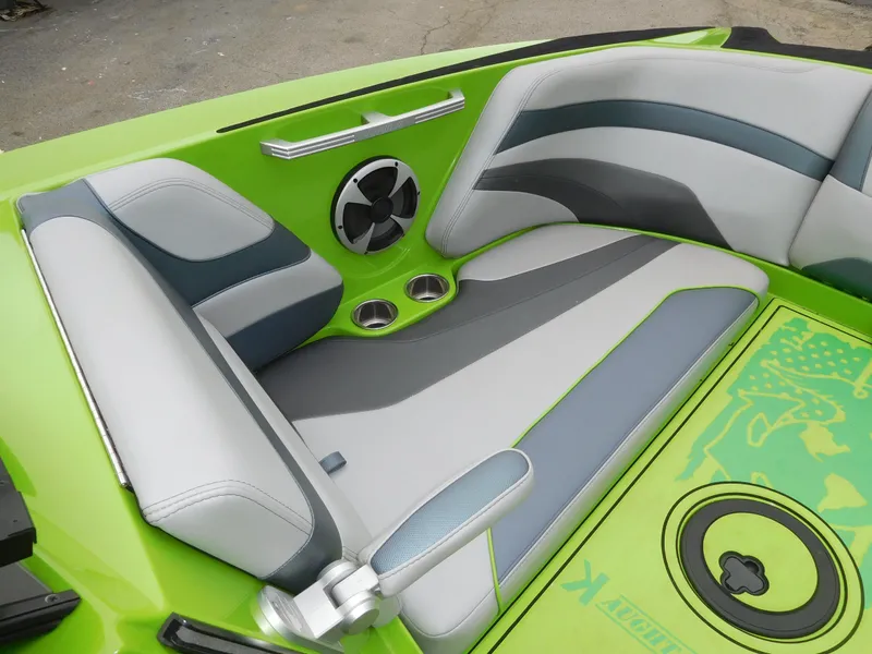 Slide: The Image of 2017 Malibu Wakesetter 24 MXZ boat interior with green and gray seating. - 40